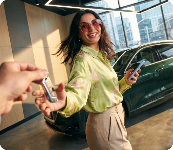 Customer being handed the keys to their new car at a dealership