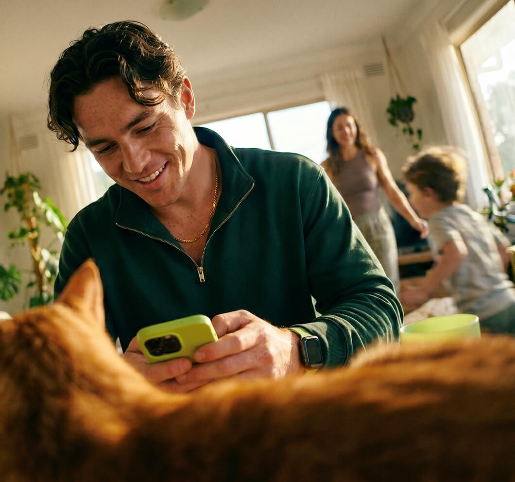 Man checking his personal loan rate on his phone at home